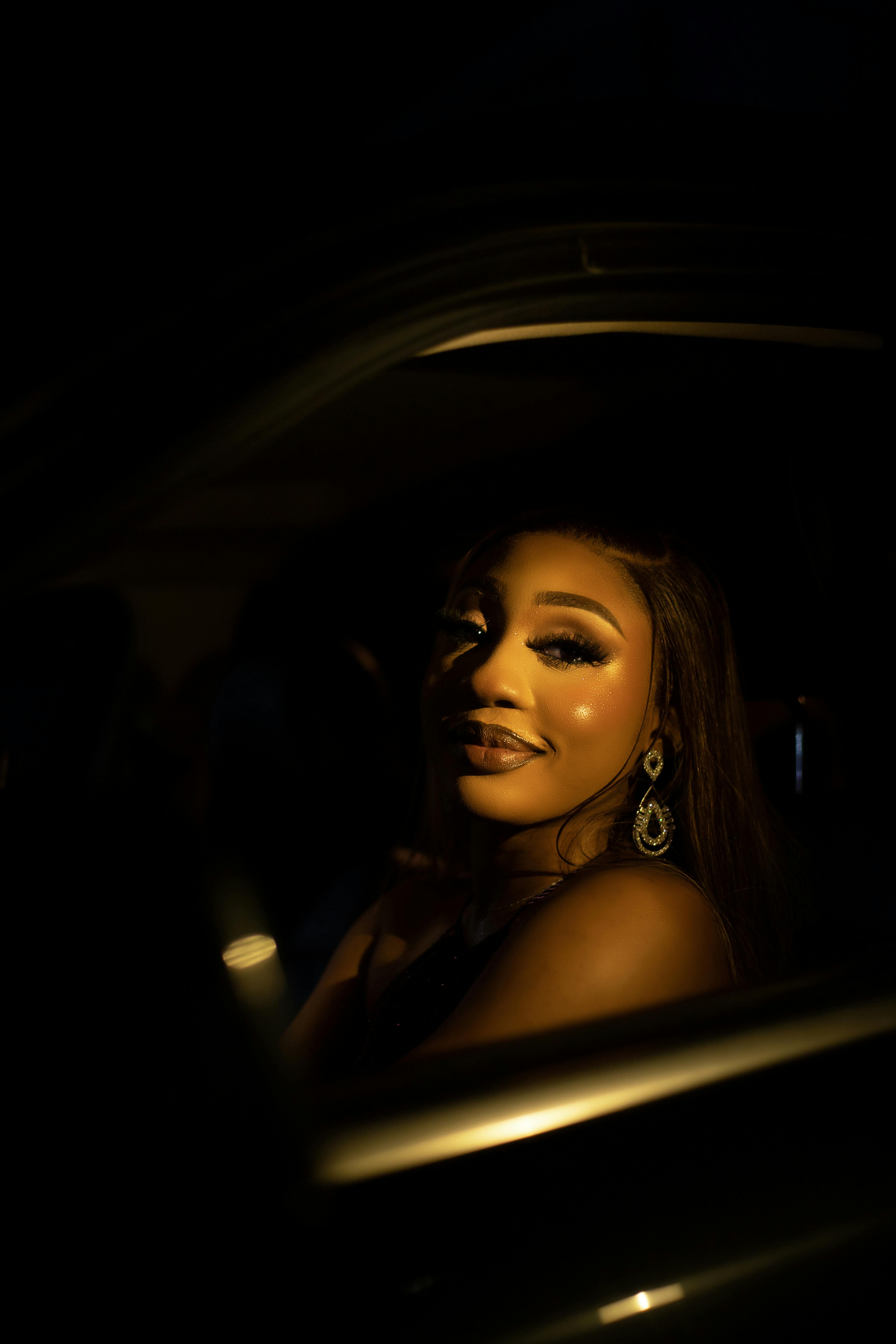 Glamorous woman in soft intimate lighting, dreamy expression with gentle glow, evoking hypnotic surrender