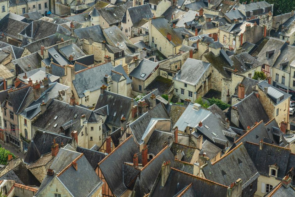 Aerial view of historic rooftops in Chinon, France, showcasing traditional architecture.