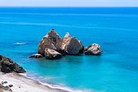 Idyllic seascape at Petra tou Romiou in Paphos, Cyprus, featuring azure waters and rocky formations.