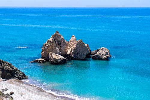 Free Idyllic seascape at Petra tou Romiou in Paphos, Cyprus, featuring azure waters and rocky formations. Stock Photo