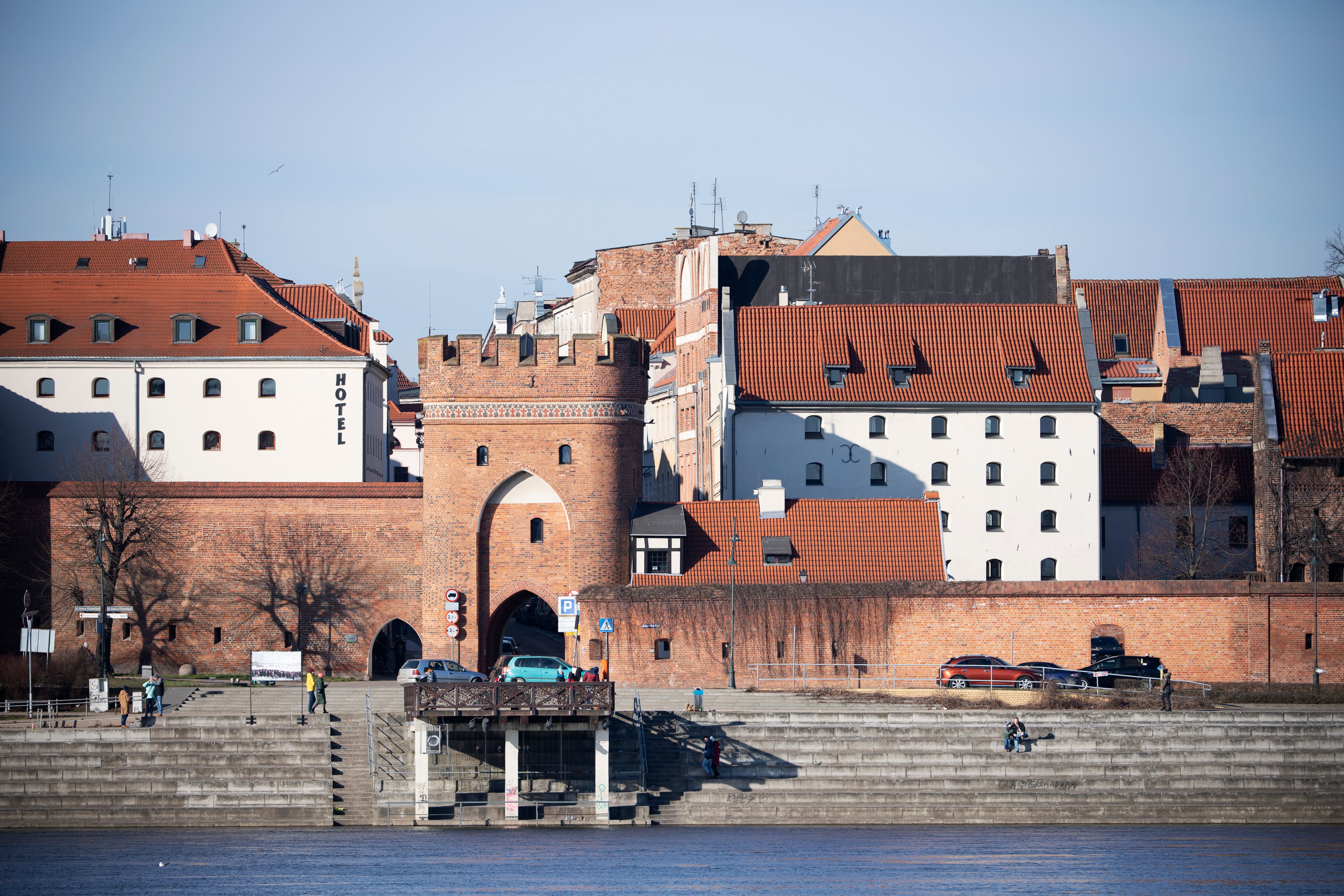 Historic City Gate by Riverside in Toruń · Free Stock Photo