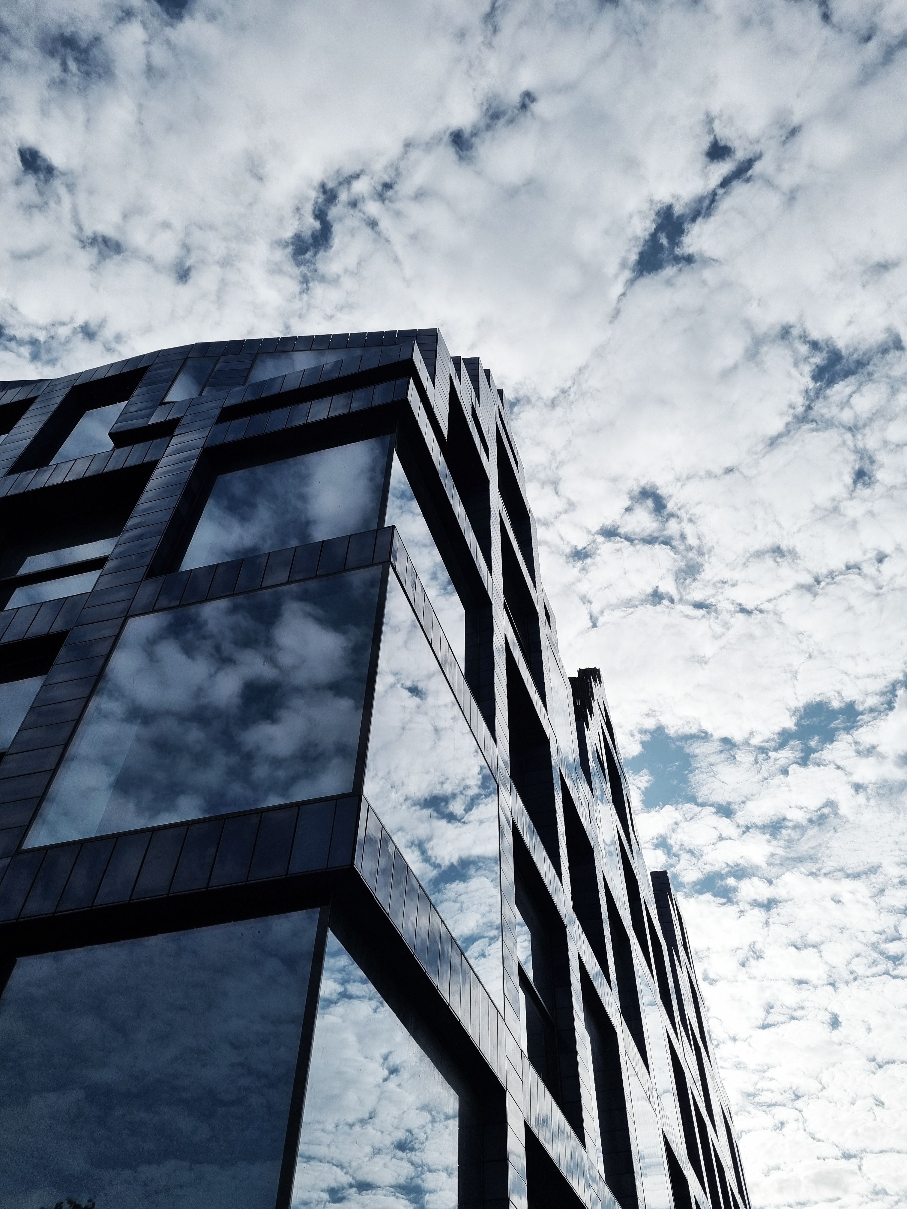 Modern Glass Building with Reflective Windows Against Cloudy Sky · Free ...