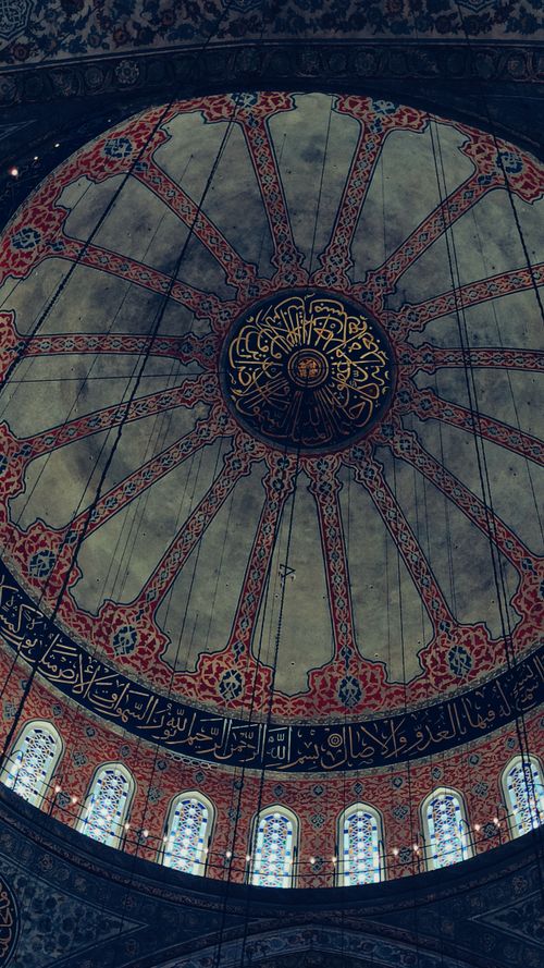 Free A detailed view of the Blue Mosque's ornate dome with elegant Arabic calligraphy and stained glass. Stock Photo