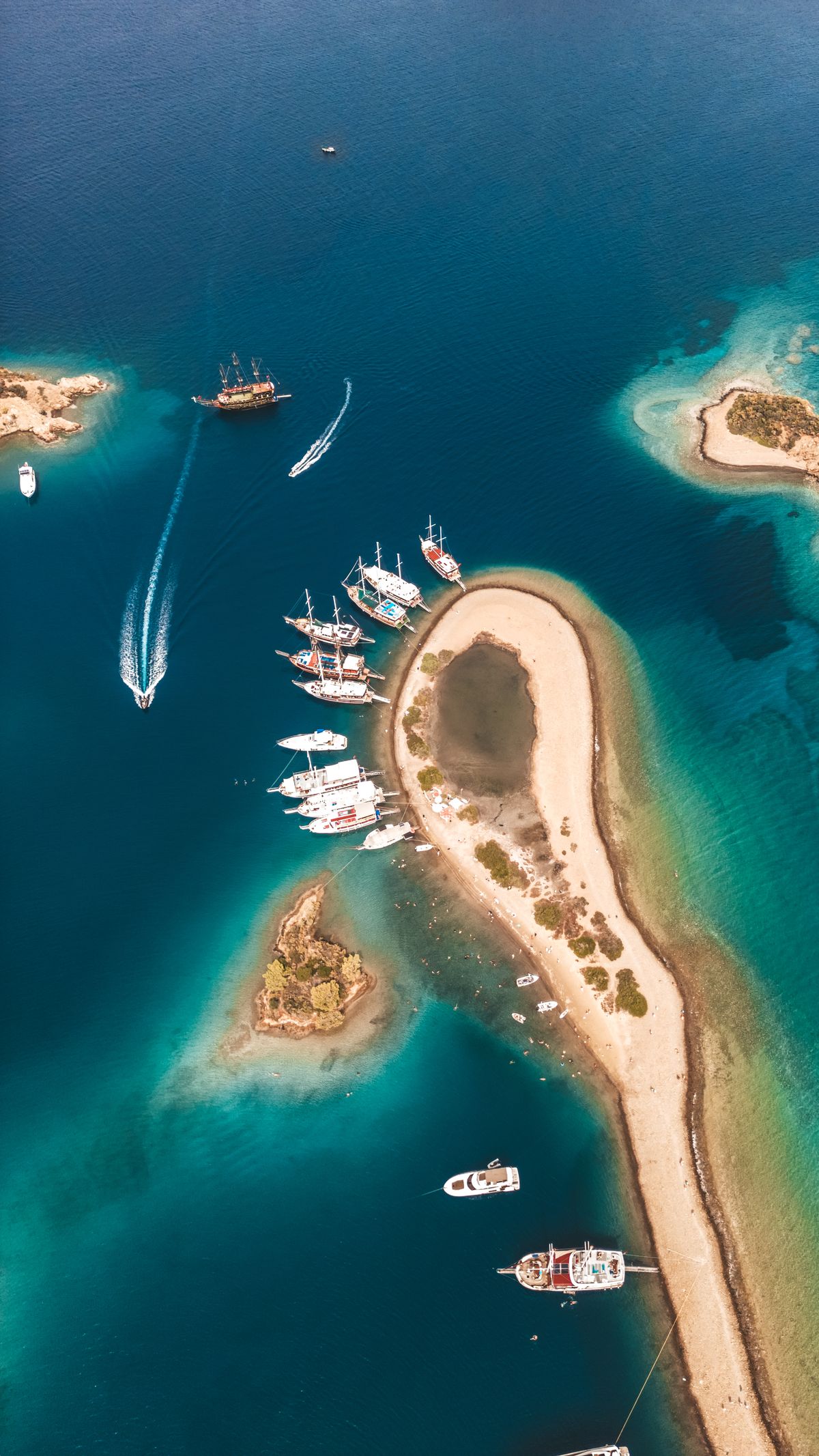 Aerial View of Boats on Vibrant Blue Water Coastline · Free Stock Photo