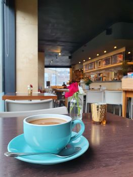 Enjoy a warm cup of coffee in a stylish London cafe, capturing the serene ambiance of city life.