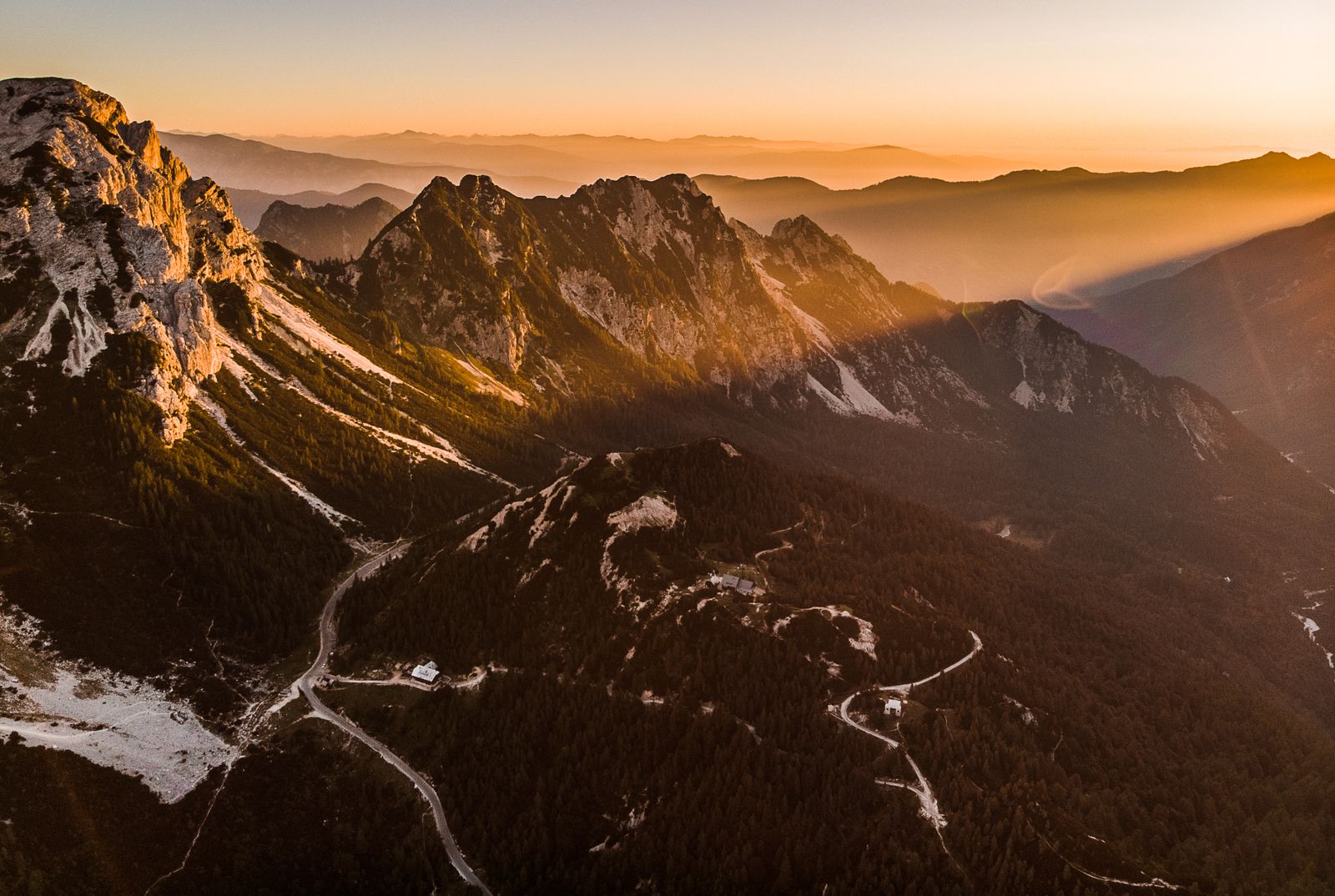 Aerial view of a rocky mountain range lit by sunrise — photo by David Bartus on Pexels