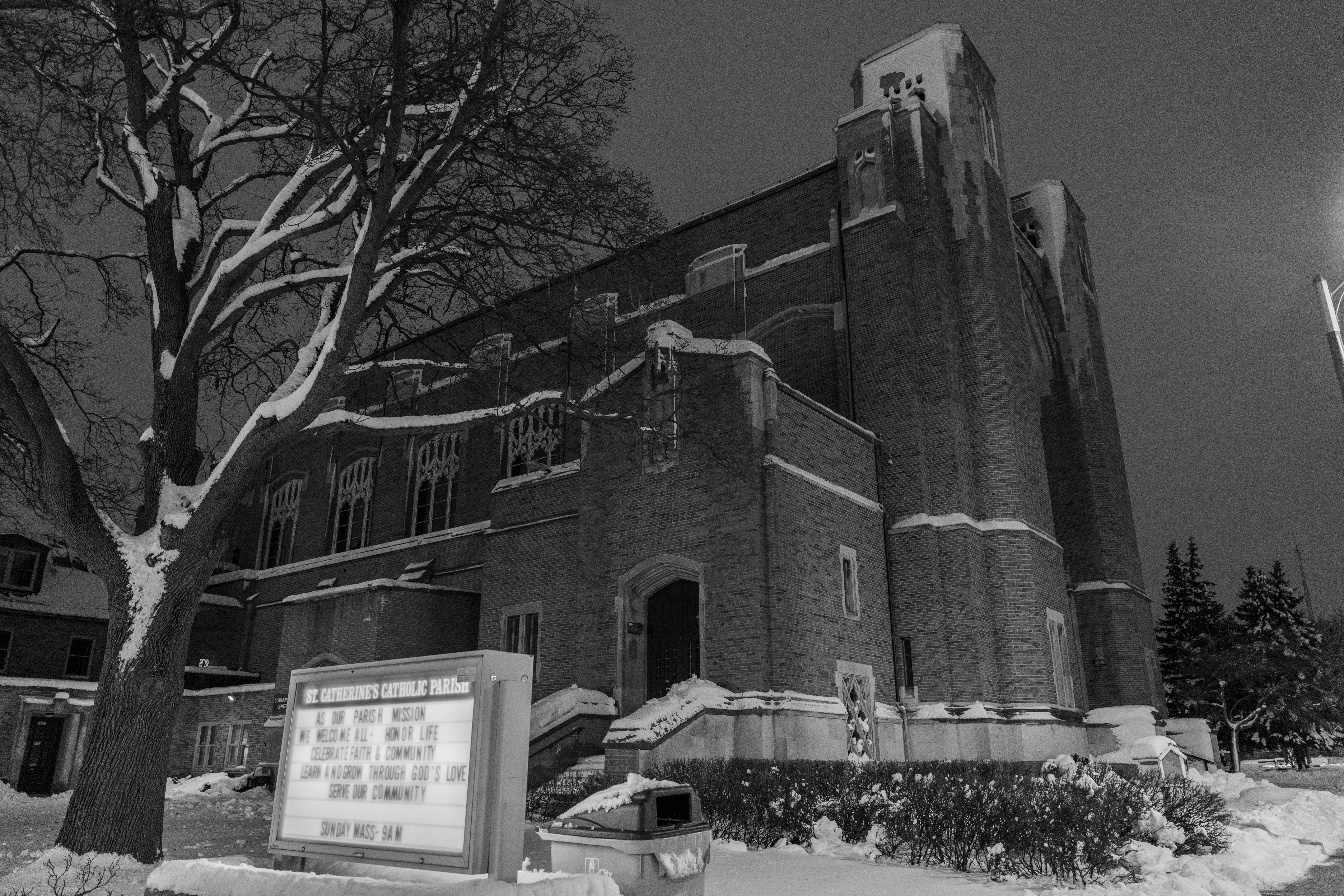 Free Black and white photo capturing St. Catherine's Church in winter snow, at night. Stock Photo