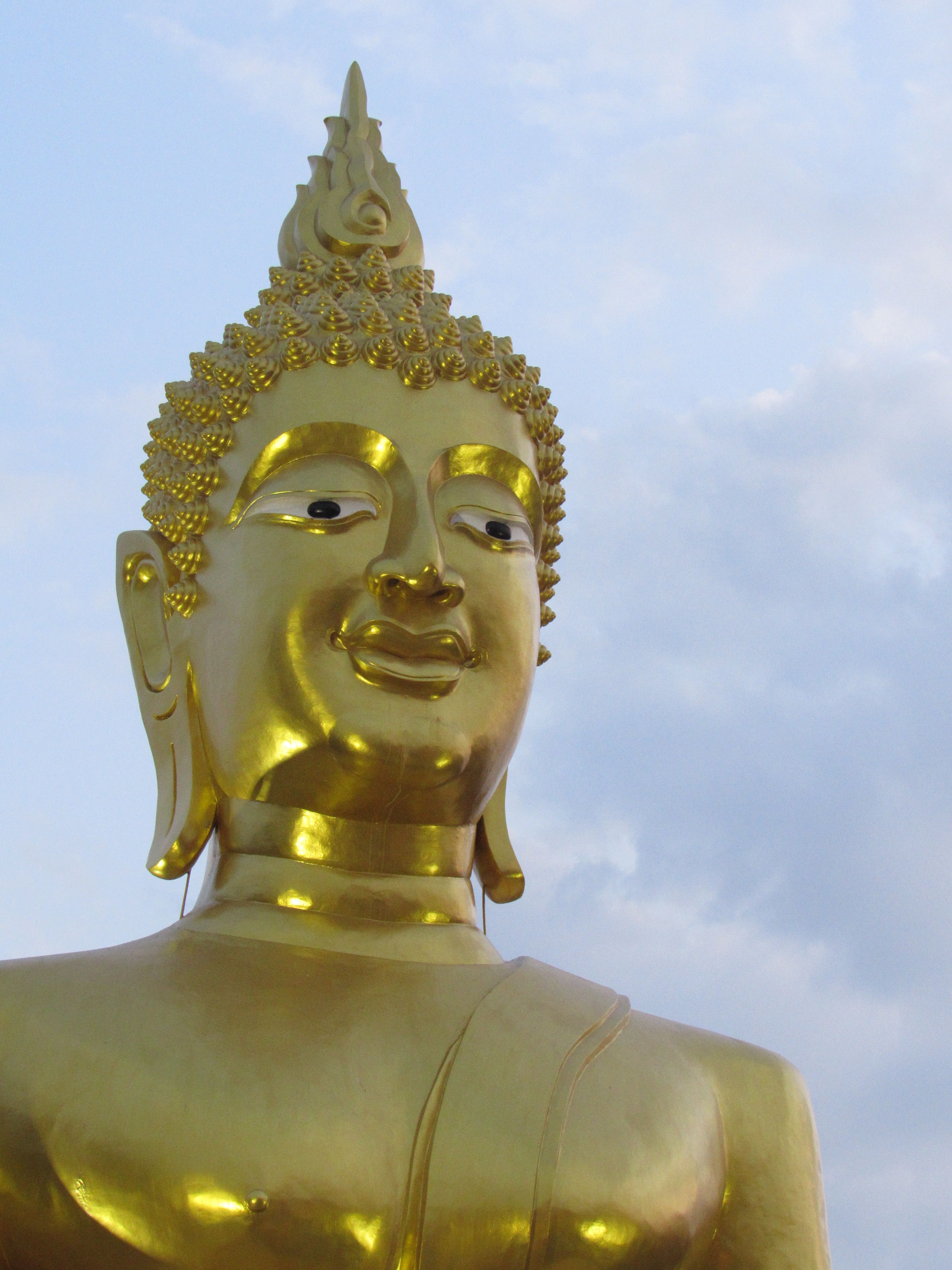 Golden Buddha Statue Against a Blue Sky · Free Stock Photo