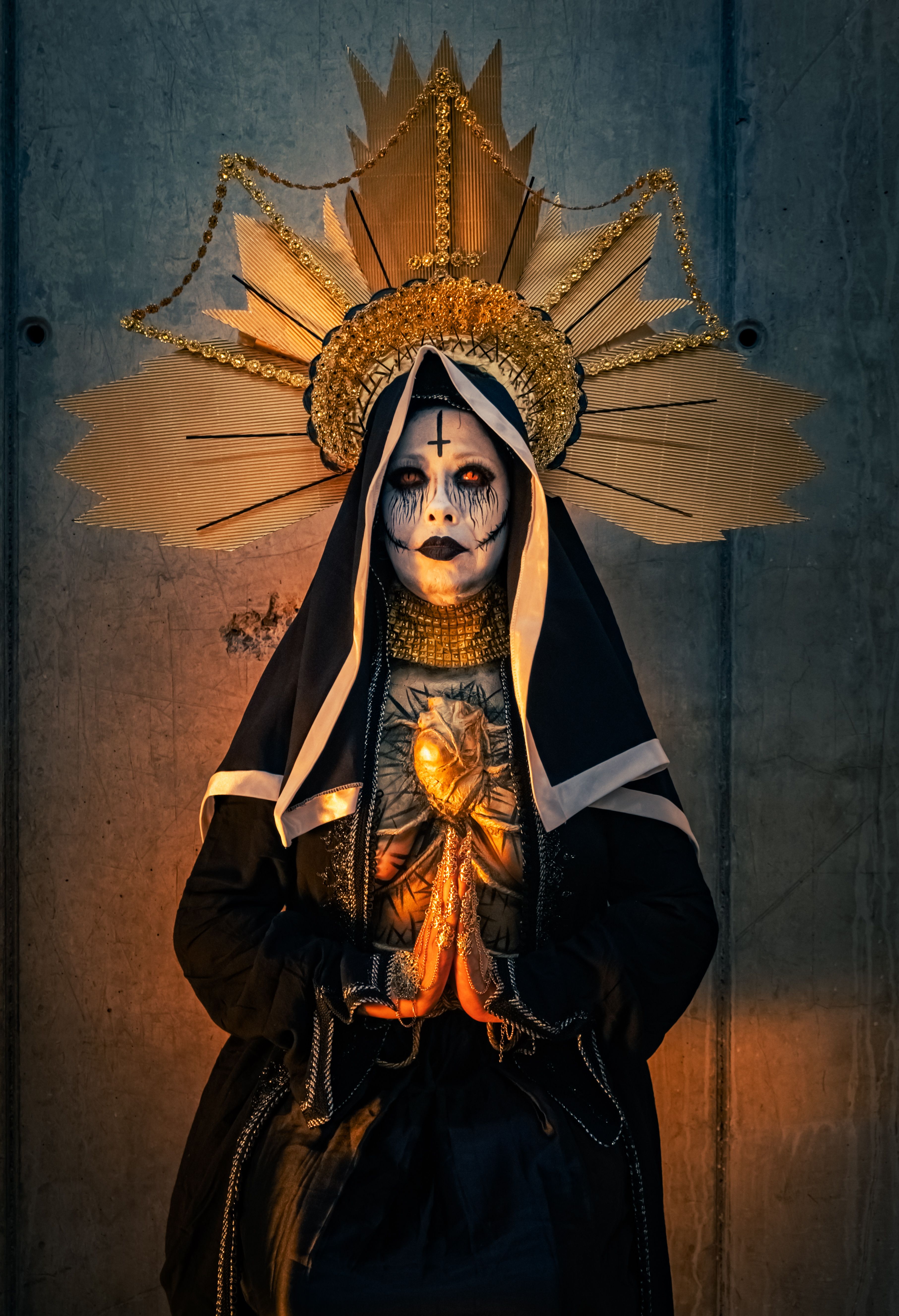 Intricate face paint on a gothic nun wearing a halo. Captivating artistic expression.