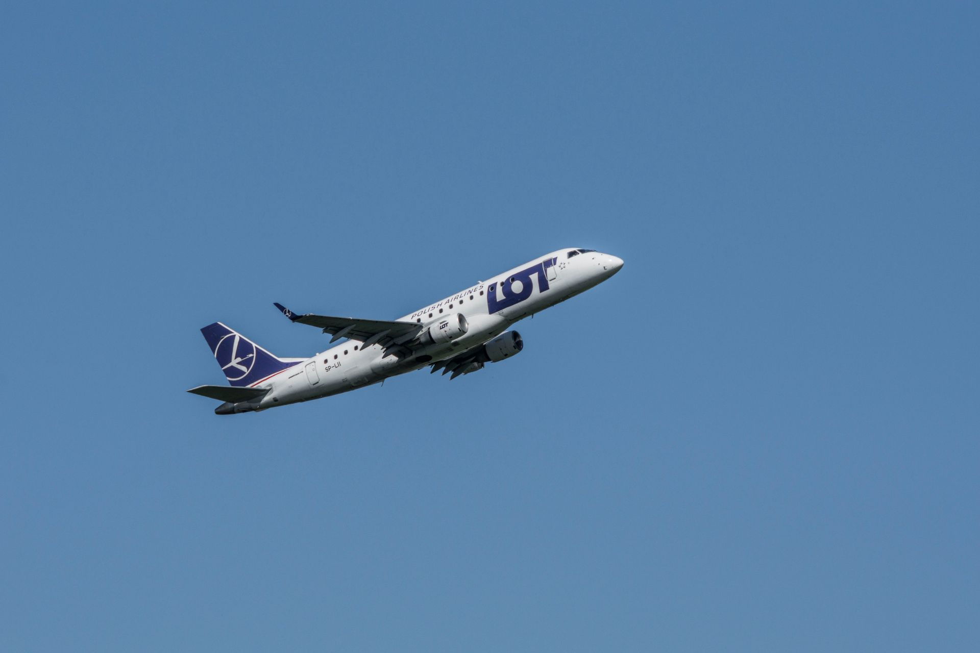 LOT Polish Airlines Plane Mid-Flight in Blue Sky