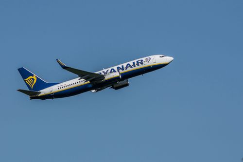 Free Ryanair Boeing 737 aircraft taking off in clear blue skies over Wrocław. Stock Photo