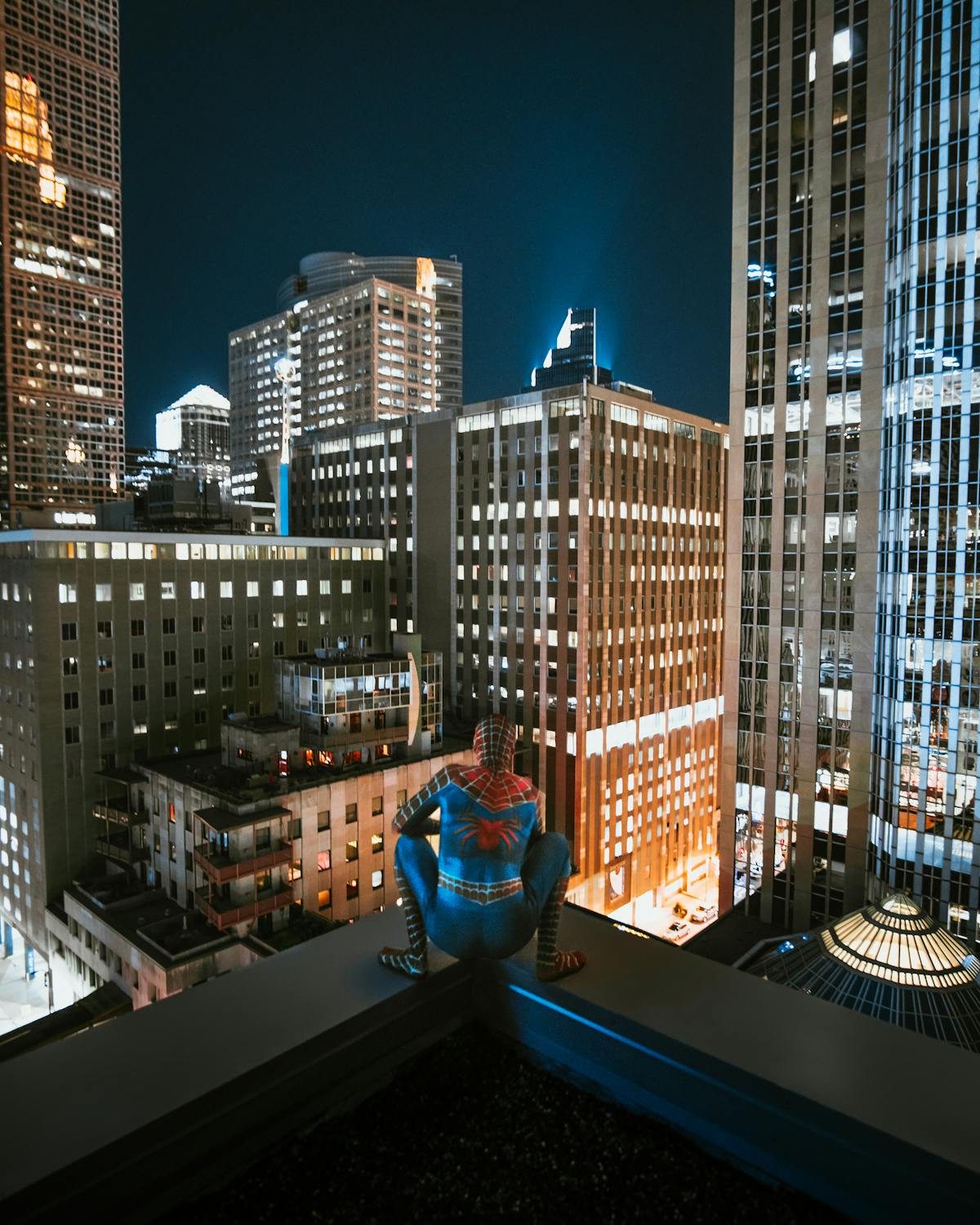 Spiderman on top of a high-rise building