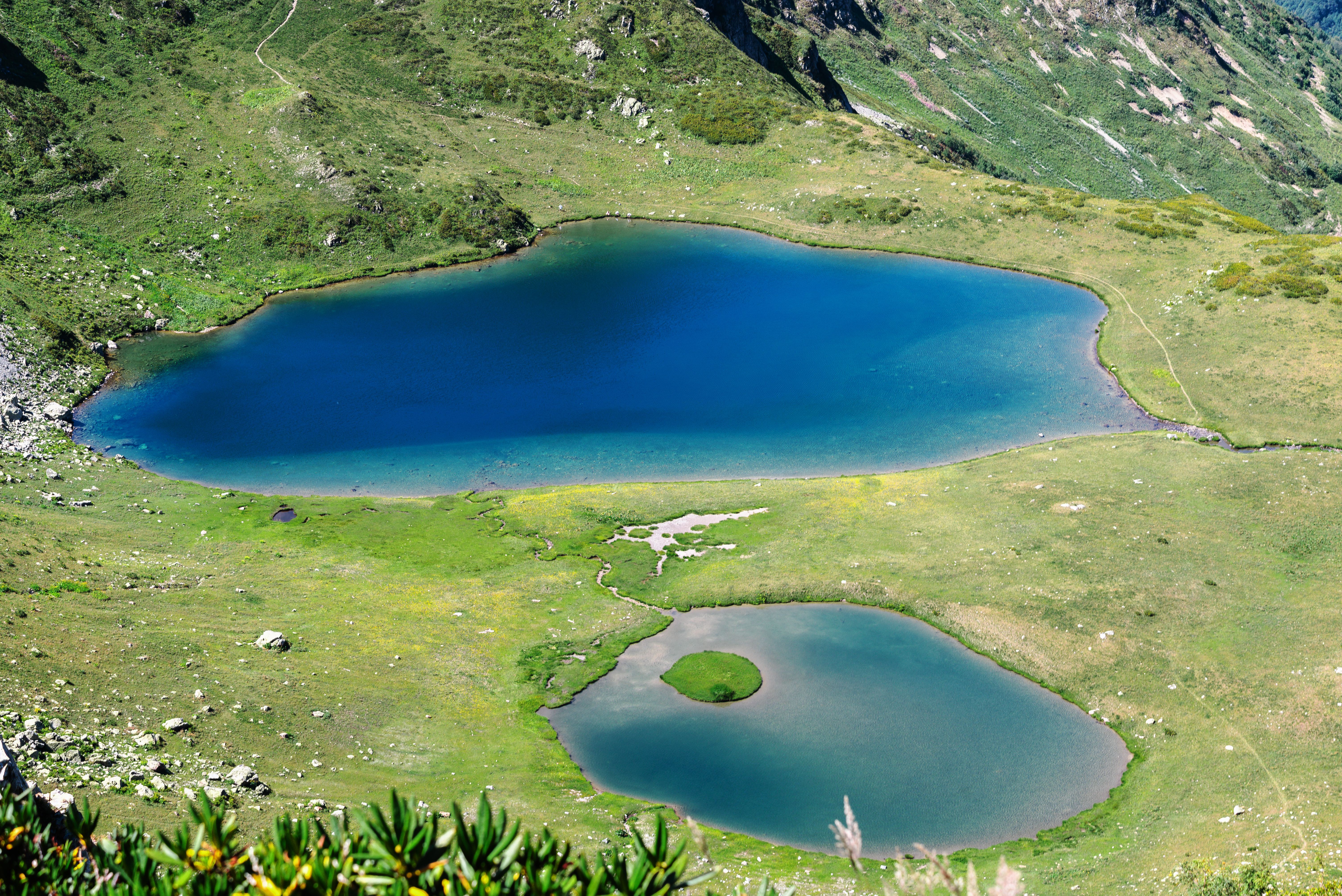 Aerial view of two serene mountain lakes surrounded by lush greenery in Гагра, Abkhazia.