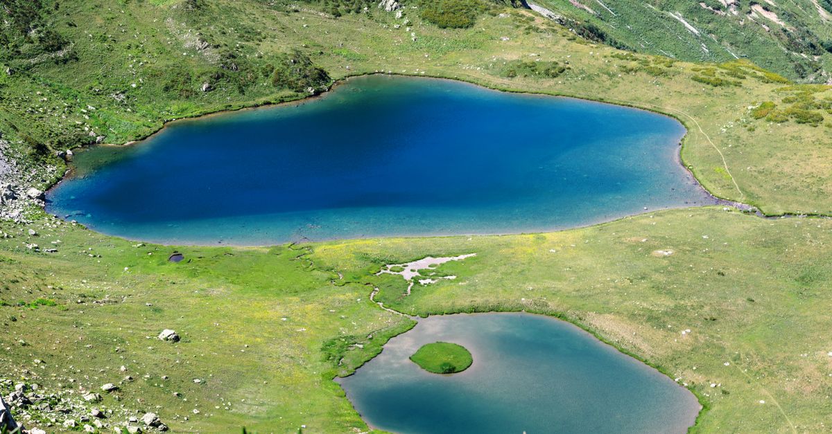 Aerial view of two serene mountain lakes surrounded by lush greenery in Гагра, Abkhazia.