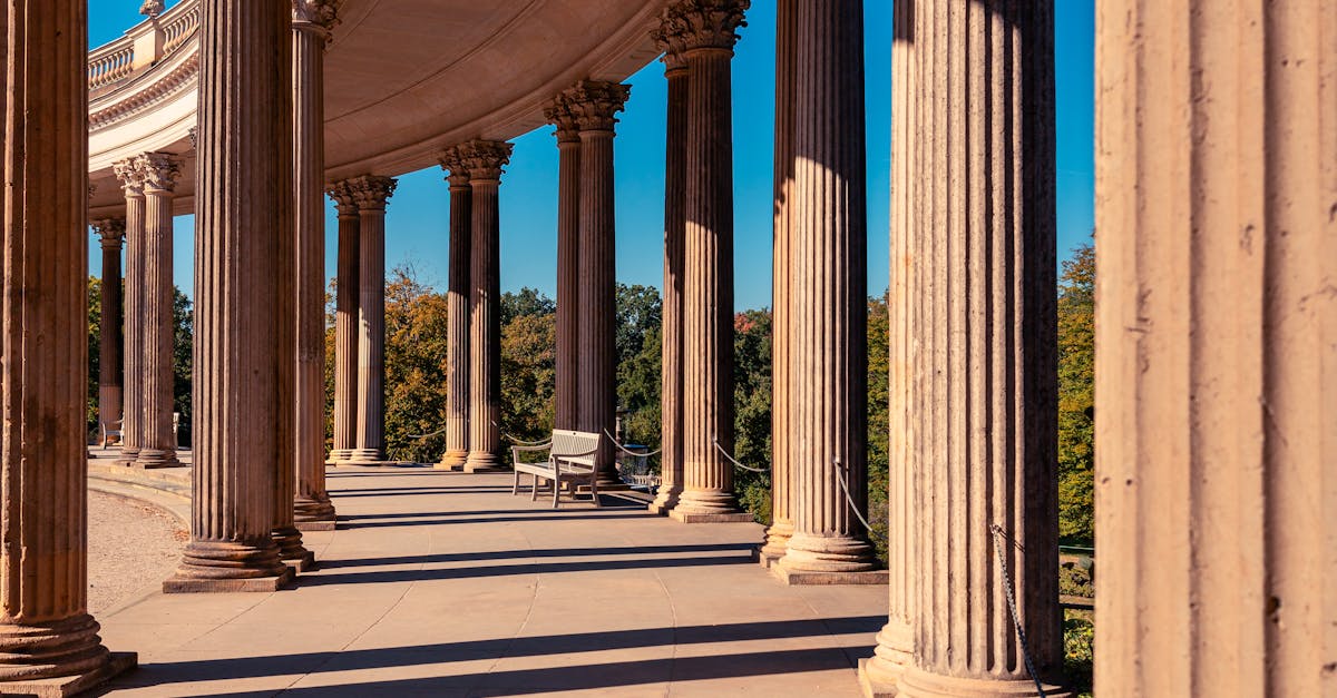 Elegant Classical Columns in Sunlit Colonnade · Free Stock Photo