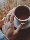 A Hand Over  A Cup Of Tea