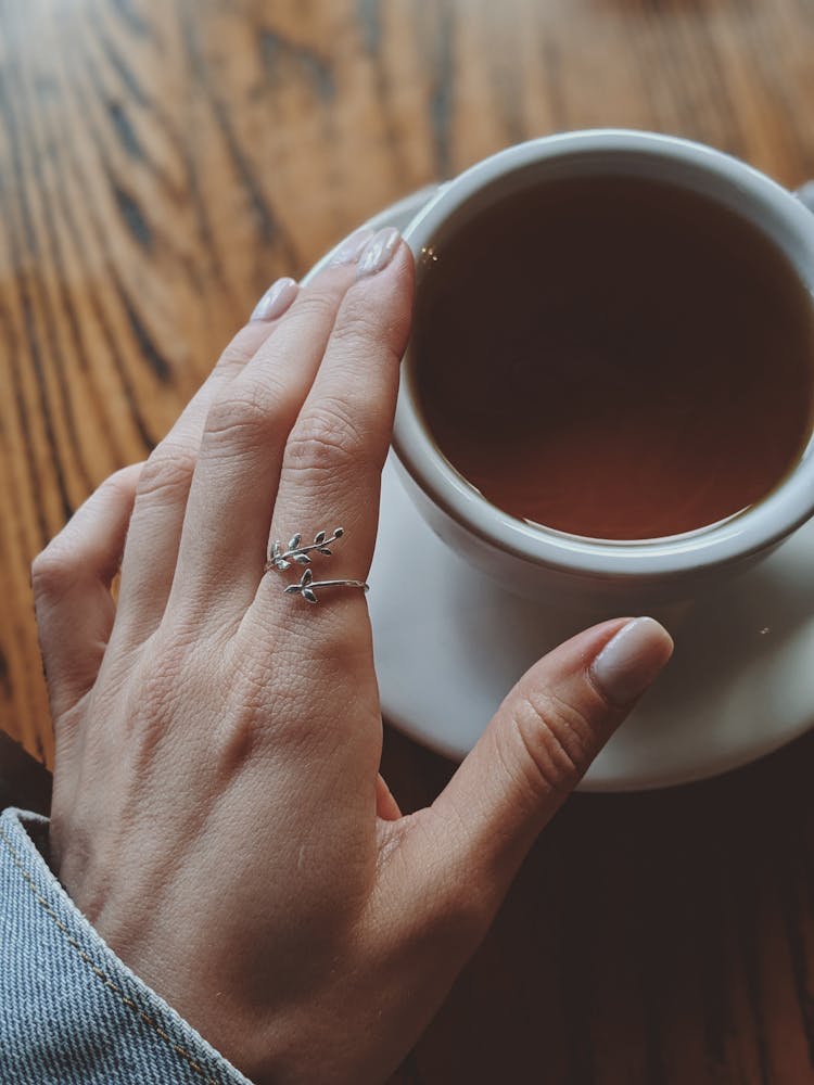 A Hand Over  A Cup Of Tea