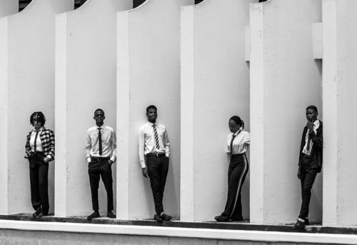 Free Five professionals posing in black and white with a modern architectural backdrop. Stock Photo
