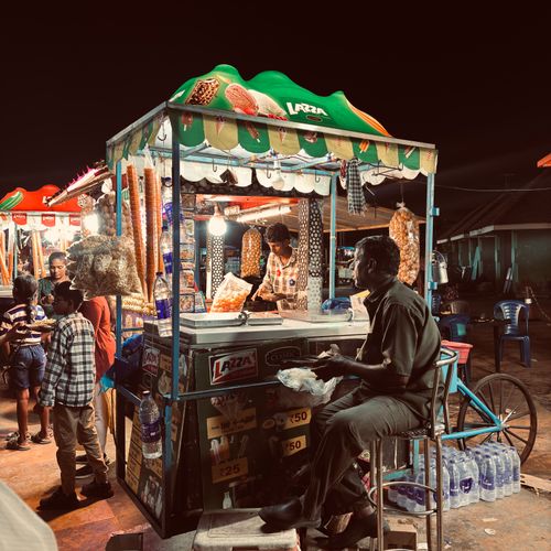 Free Colorful scene of a lively street food market at night in Thiruvananthapuram, Kerala, India. Stock Photo
