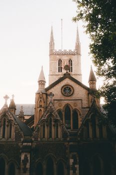 A majestic Gothic Revival church captured during sunset, showcasing stunning architectural details.