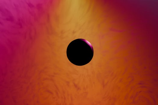 Vibrant abstract background with a central black sphere, featuring a gradient of pink and orange swirls.