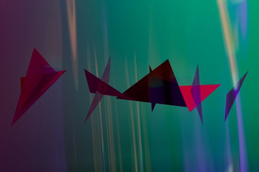 A vibrant composition of abstract geometric shapes in red and purple against a green and blue gradient.
