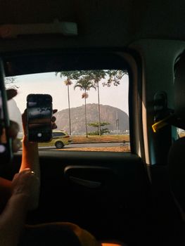 Capturing the iconic Sugarloaf Mountain through a car window in Rio de Janeiro, Brazil.