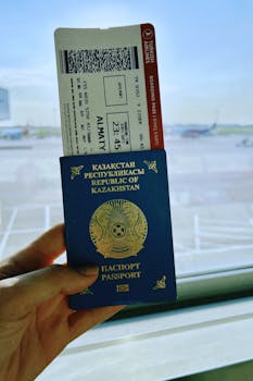 Kazakhstan passport with boarding pass in Warsaw airport, ready for travel.