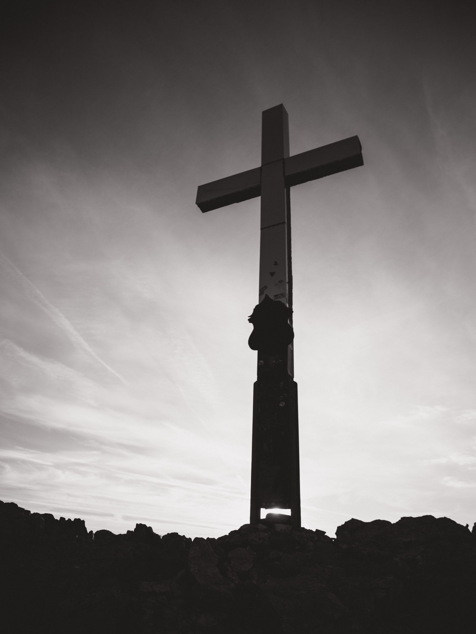 A cross silhouetted against a golden sunrise, symbolizing the light of Jesus breaking over the nations.