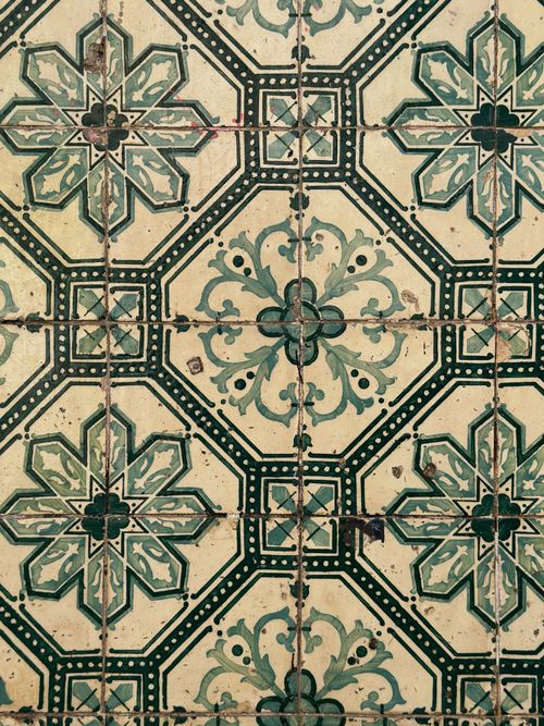 Free Ornate vintage ceramic tile with floral patterns and geometric designs, green and beige. Stock Photo