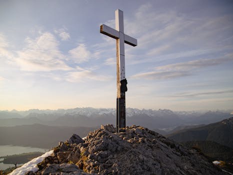 Panoramic alpine scenery with a cross on the summit in Garmisch-Partenkirchen, Germany.