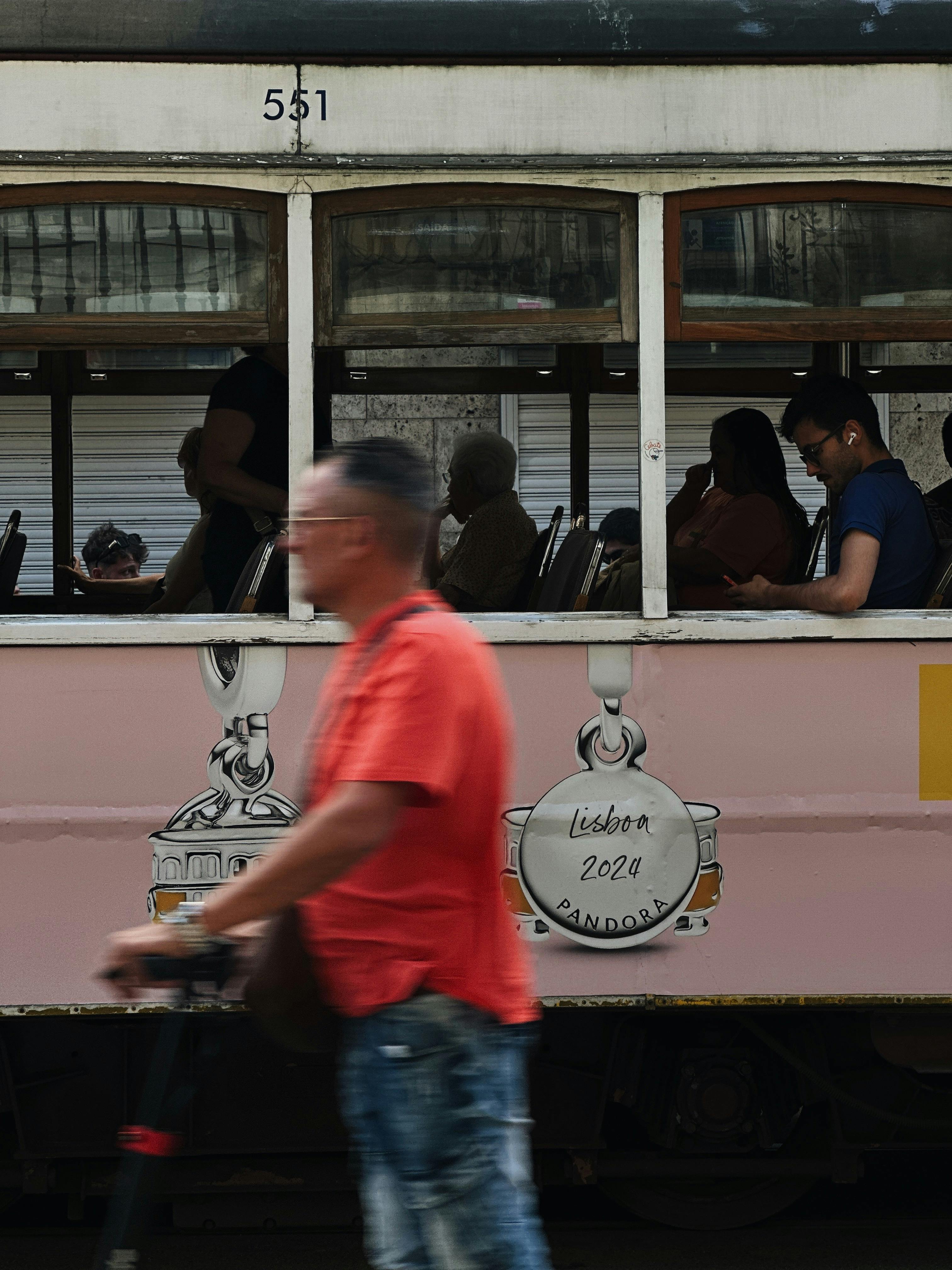 vintage lisbon tram with passengers inside