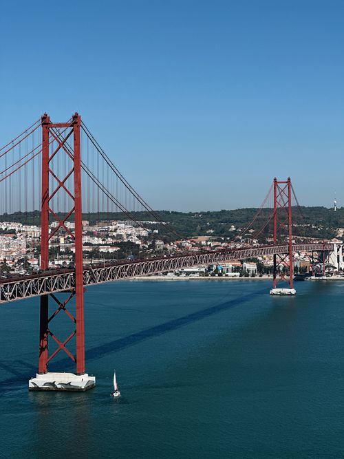 Free Scenic aerial view of the 25 de Abril Bridge spanning the Tagus River in Lisbon. Stock Photo