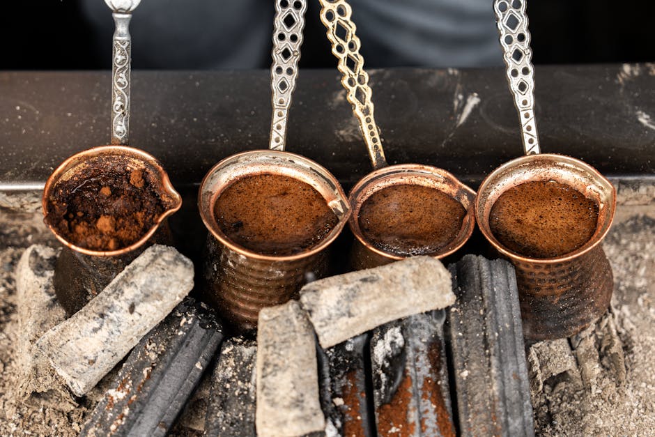 pexels photo 28554507 Close-up of Turkish coffee brewing in copper cezves over hot coals in İstanbul.