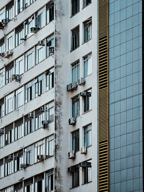 Free High-rise buildings with air conditioners on windows, modern urban architecture. Stock Photo