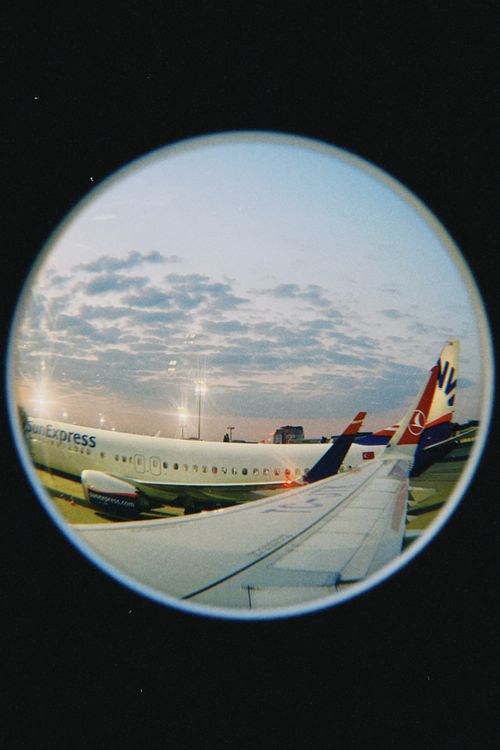 Free Unique fisheye lens capture of airplanes at sunset, Warsaw Airport, Poland. Stock Photo