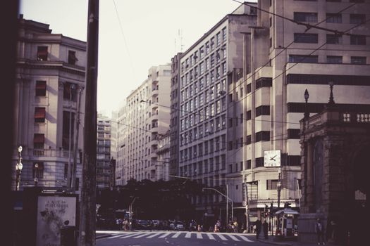 Bustling street scene in São Paulo, showcasing historic architecture and urban life.