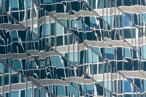Free Abstract pattern of reflections on a glass office building facade. Stock Photo