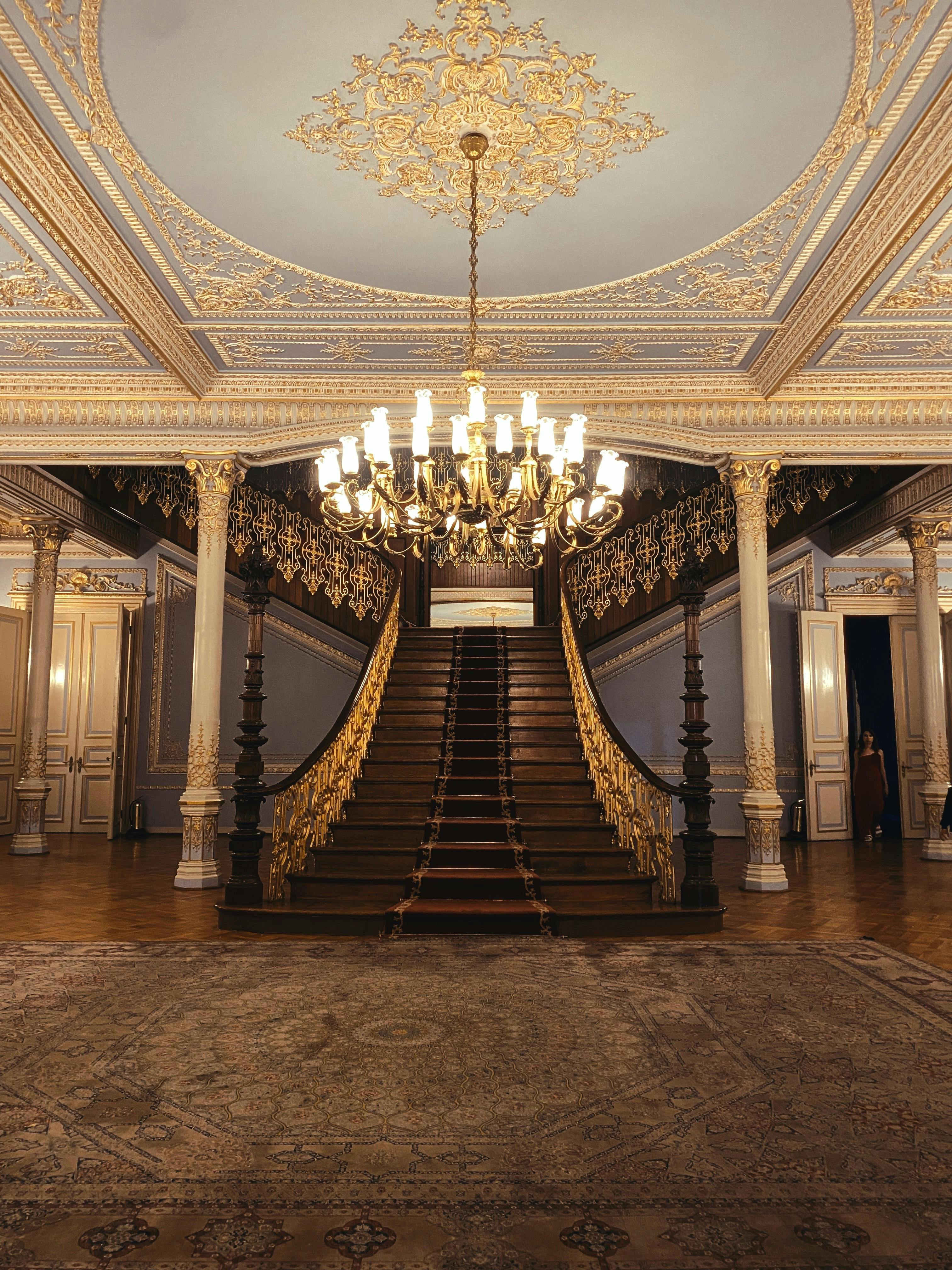 Free Lavish interior of a historic Istanbul palace with ornate staircase and chandelier. Stock Photo