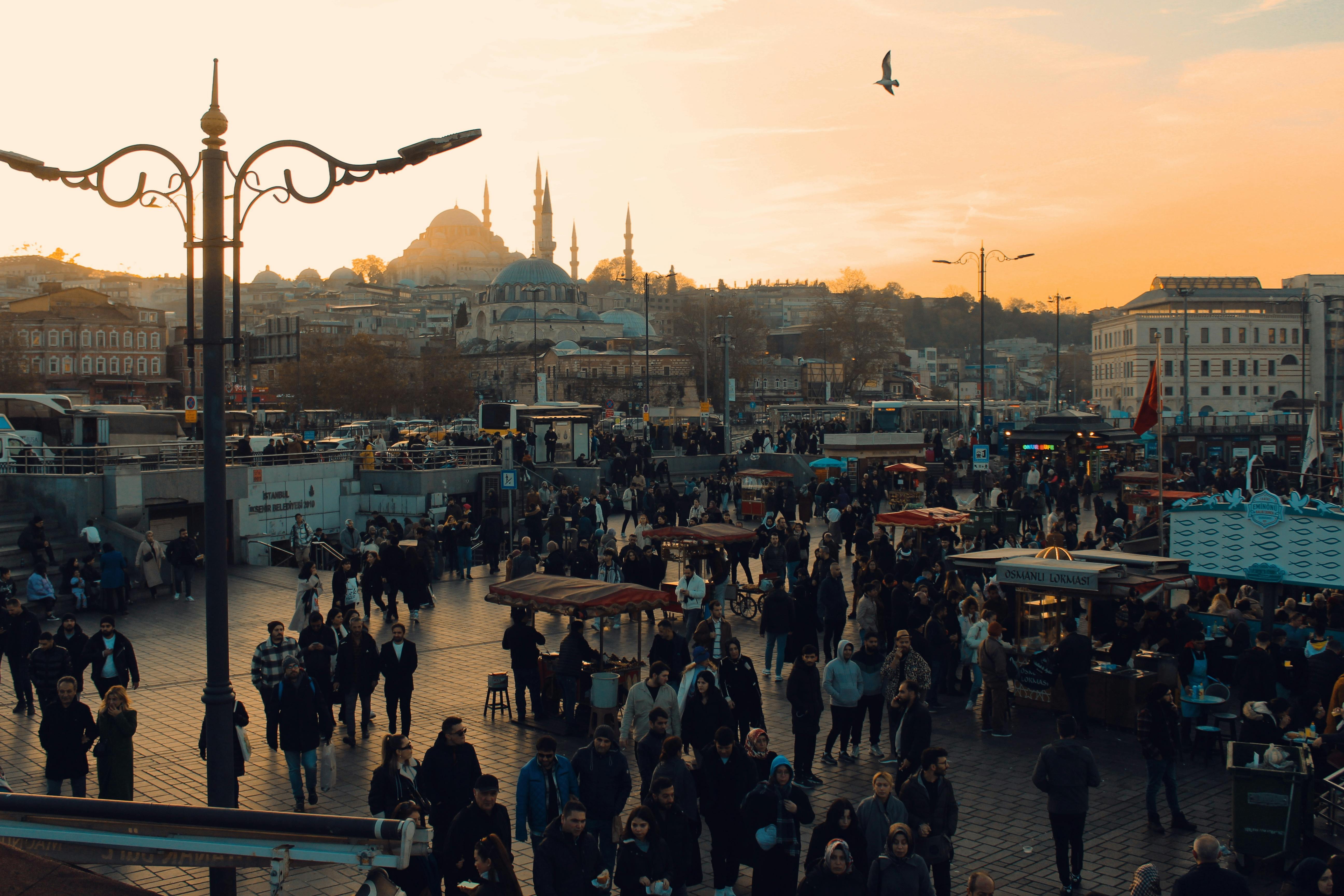 Free Busy street market scene in Istanbul with crowd at sunset, showcasing vibrant city life and architecture. Stock Photo
