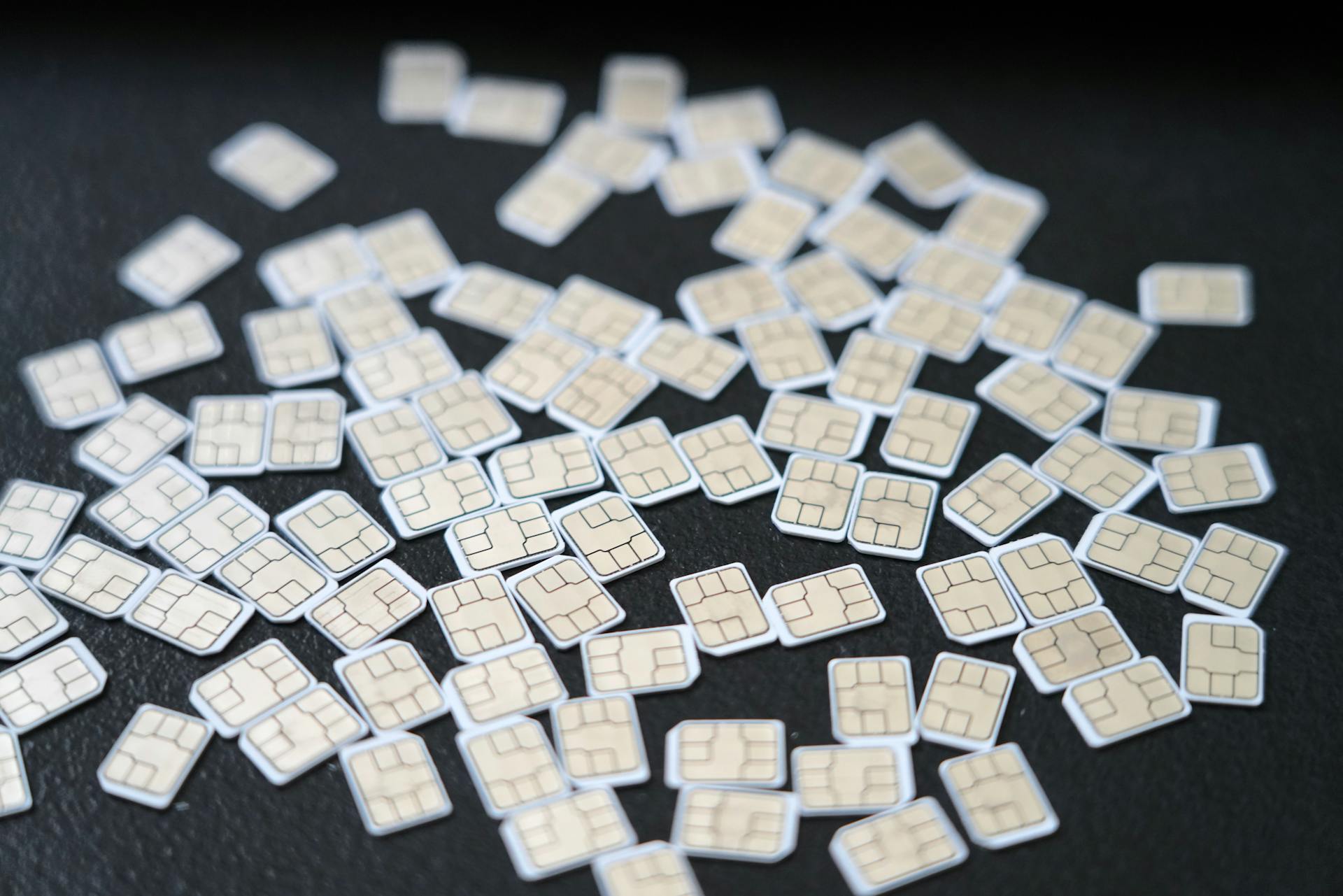 Collection of SIM Cards on a Dark Surface