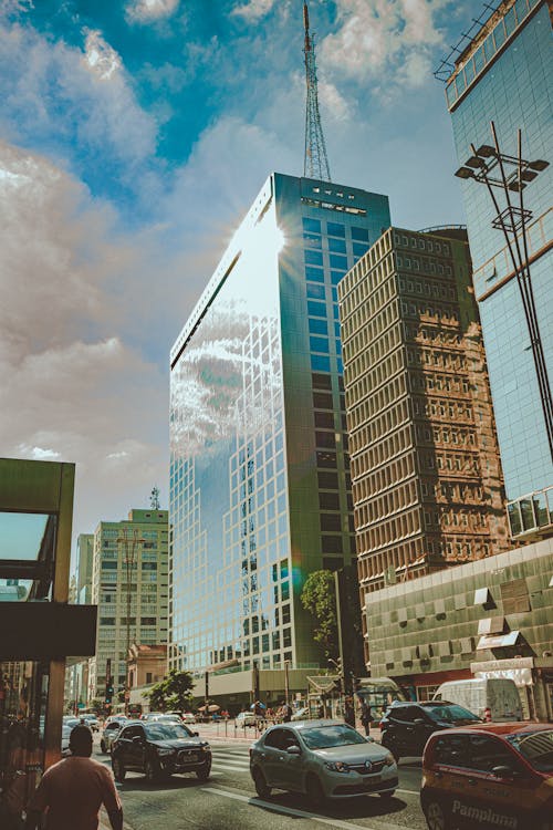 Low-angle Photo of Buildings Near Car Passing Through