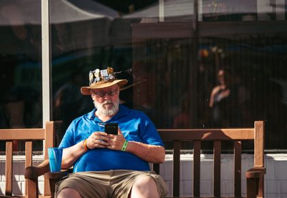 Older man on a bench with a phone