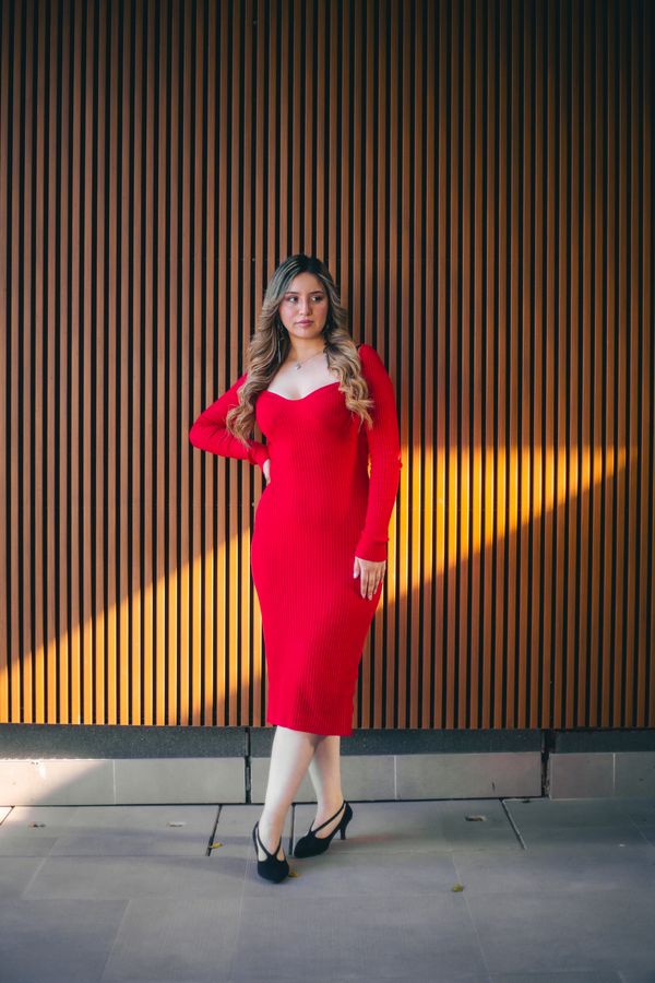 Woman in an affordable red ribbed knit dress