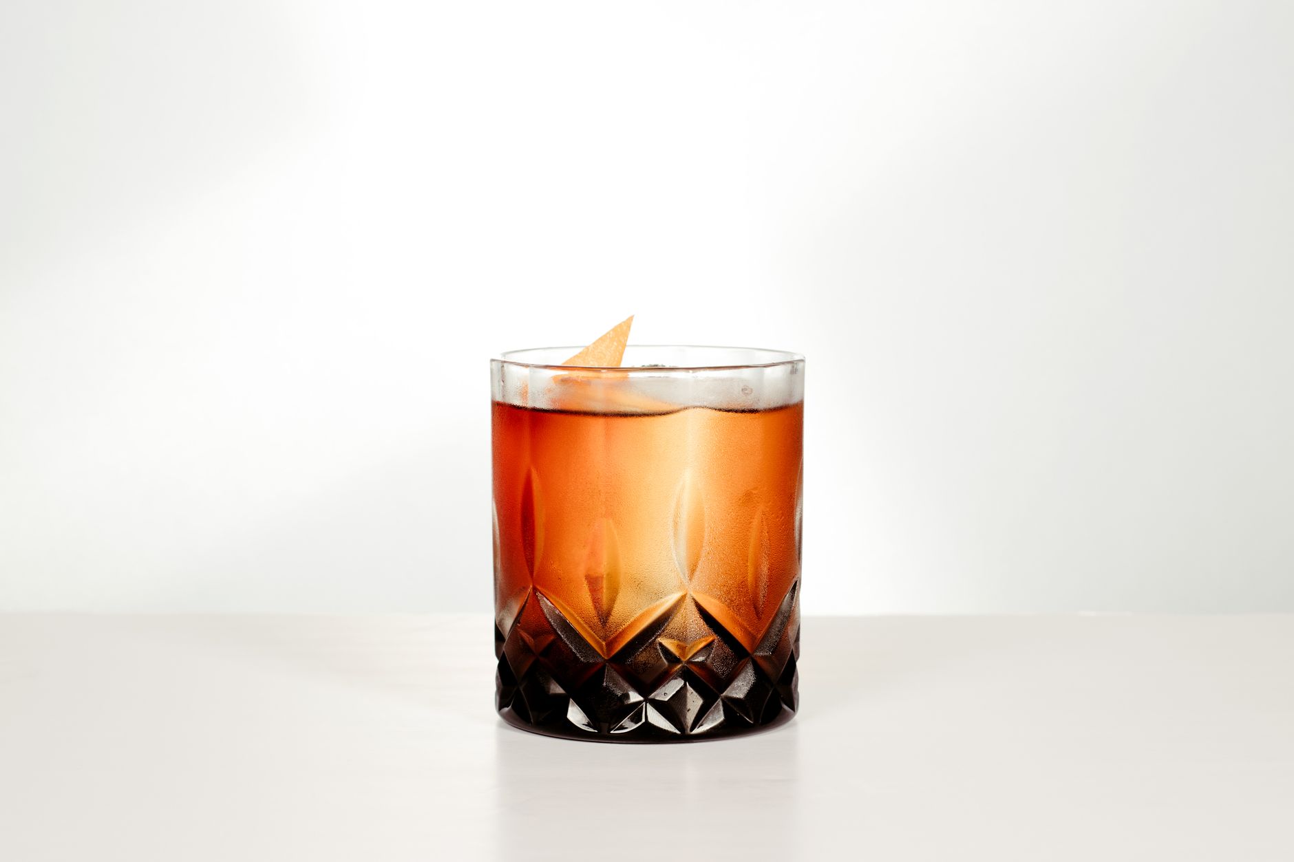 Table with glasses of aperitifs and digestifs alongside appetizers