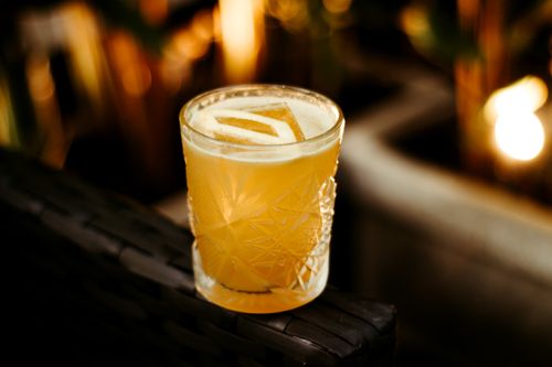 Free A beautifully shot cocktail in a crystal glass with warm ambient lighting, perfect for upscale dining or social media. Stock Photo