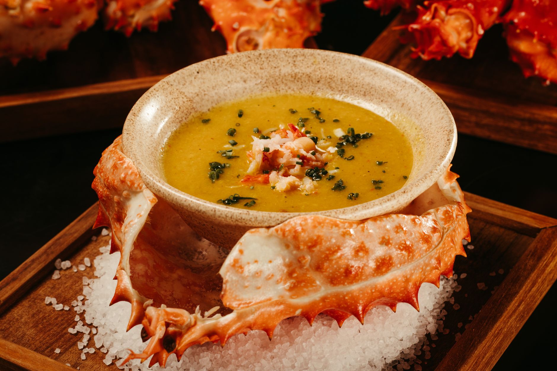 Serving bowl of shrimp bisque with garnish