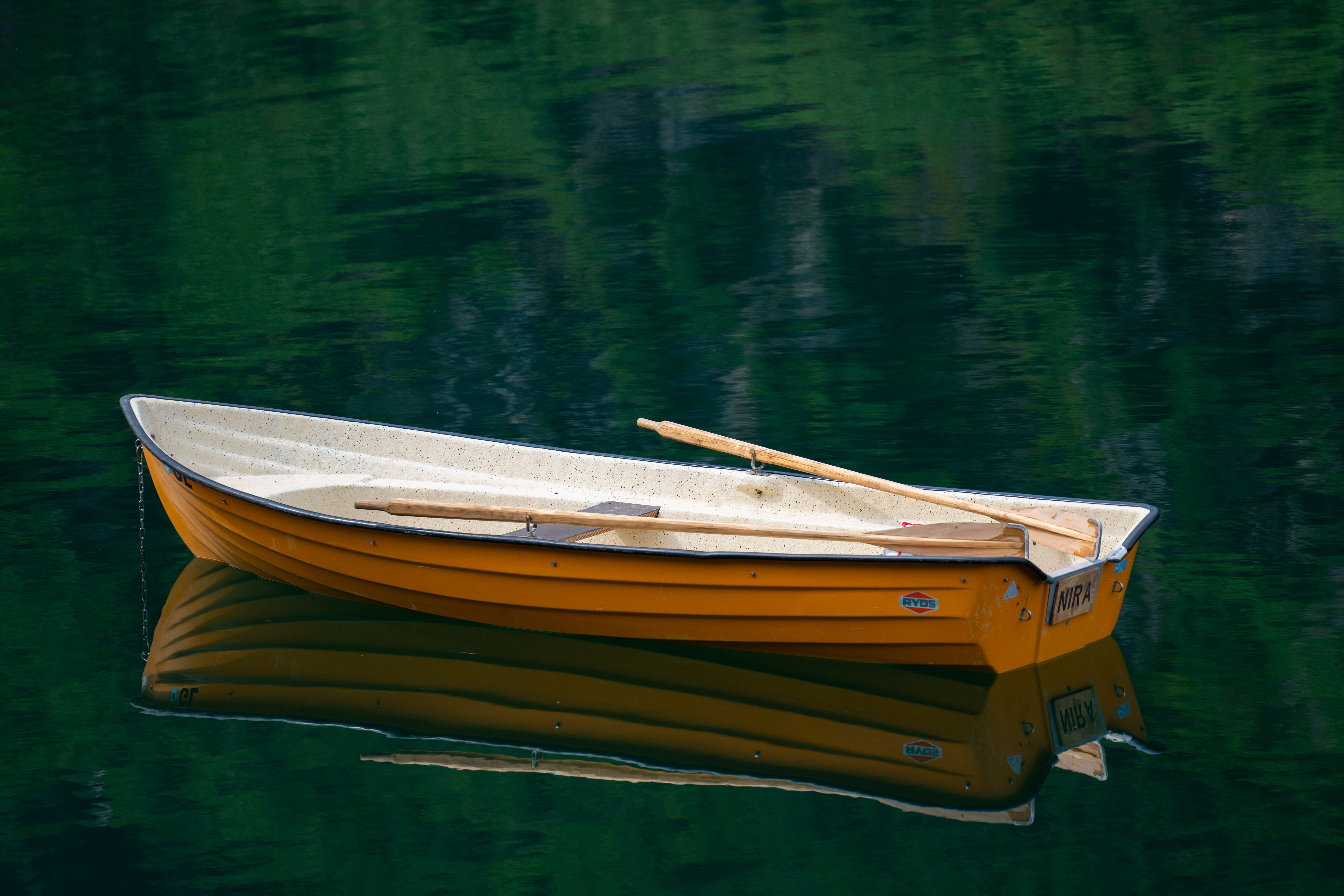 Peaceful Rowboat on Calm Lake Water · Free Stock Photo