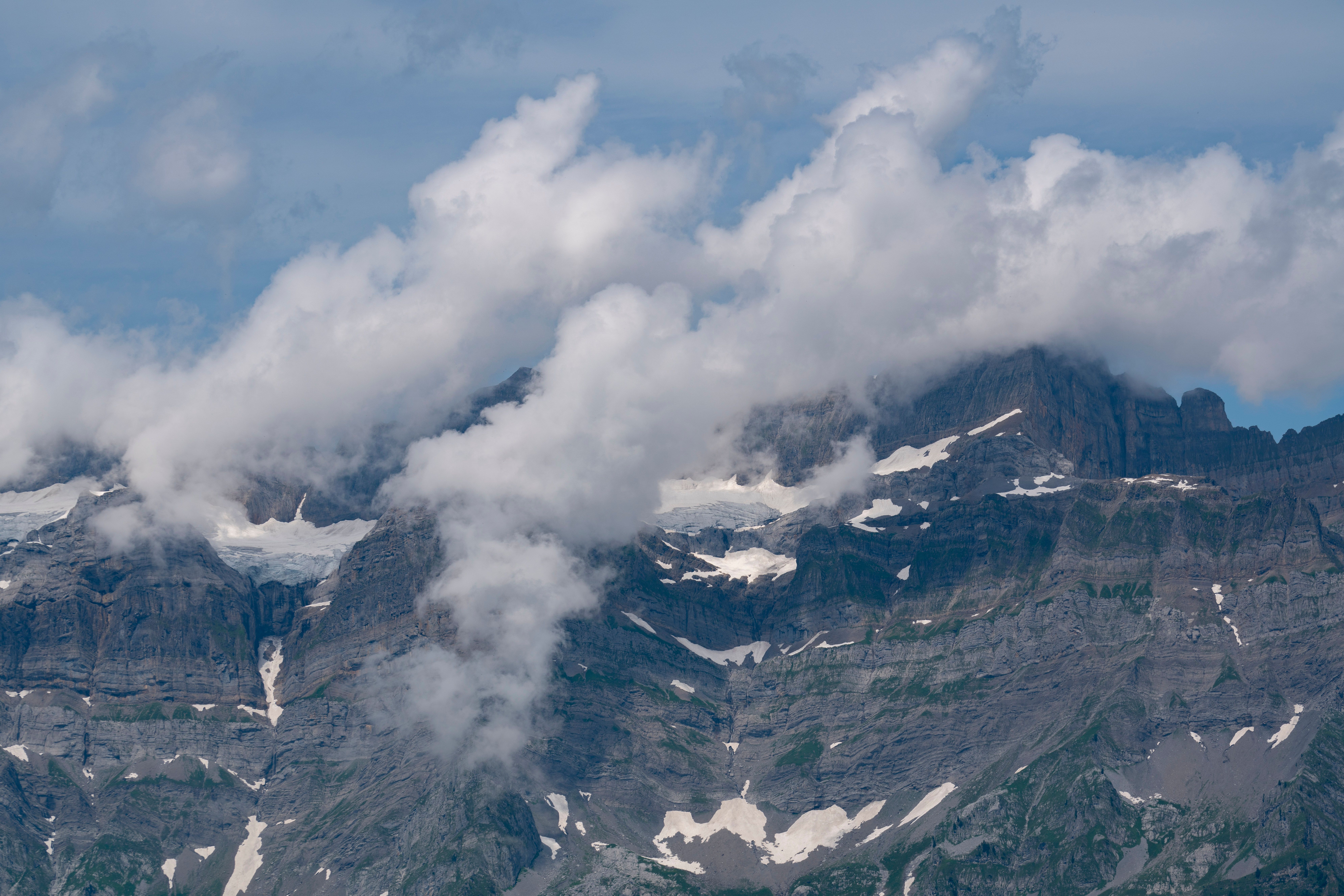 Majestic Mountain Peaks with Dramatic Clouds · Free Stock Photo