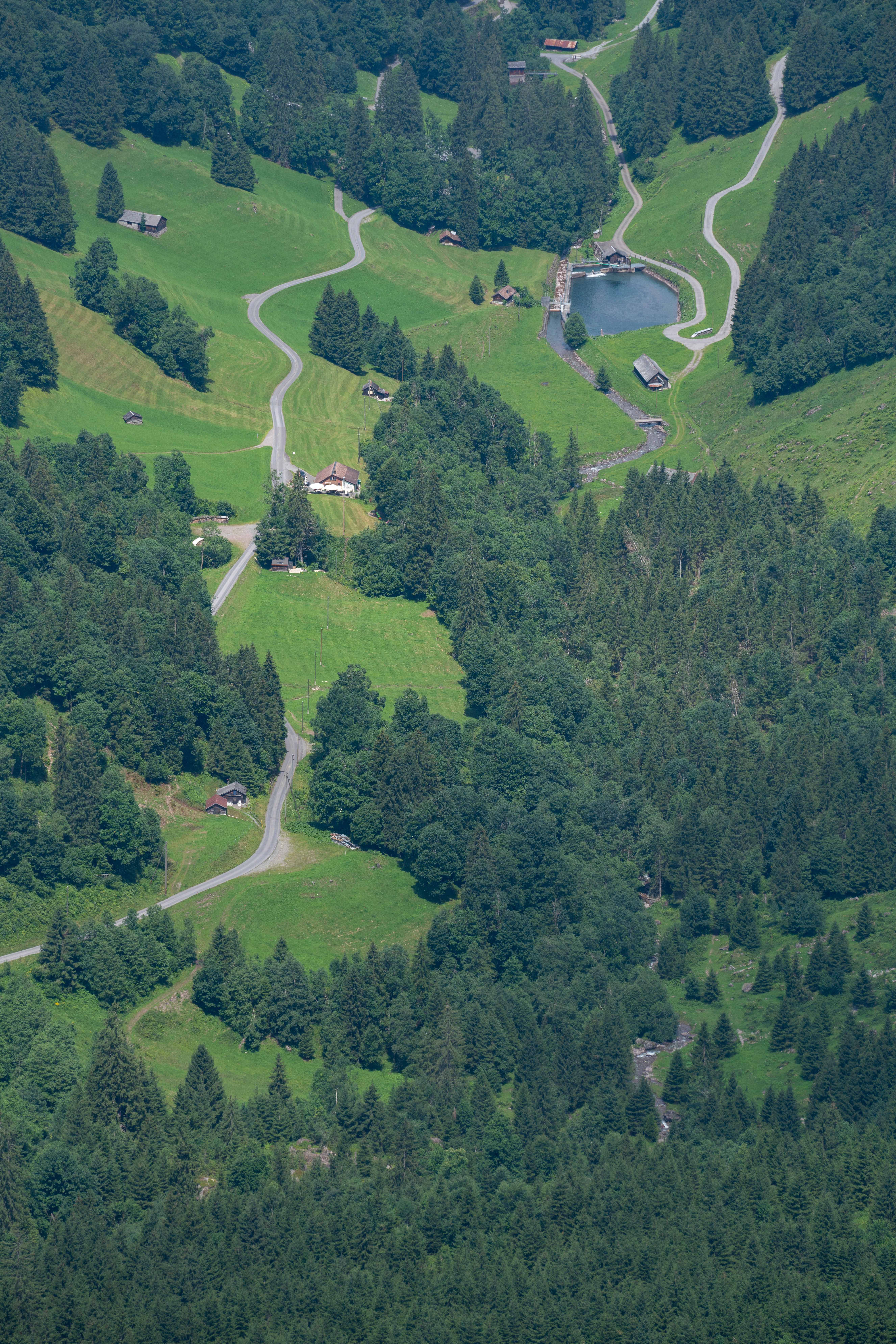 Aerial View of Lush Green Landscape with Roads · Free Stock Photo